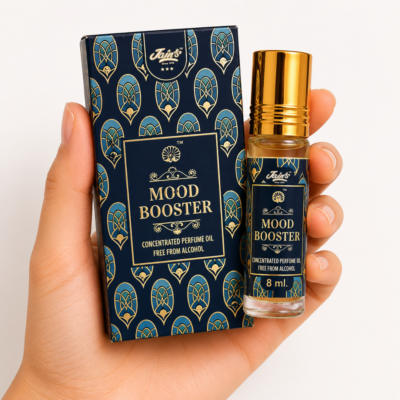 Mano neutra sosteniendo Attar Mood Booster 100% natural de Jains sobre fondo blanco minimalista.