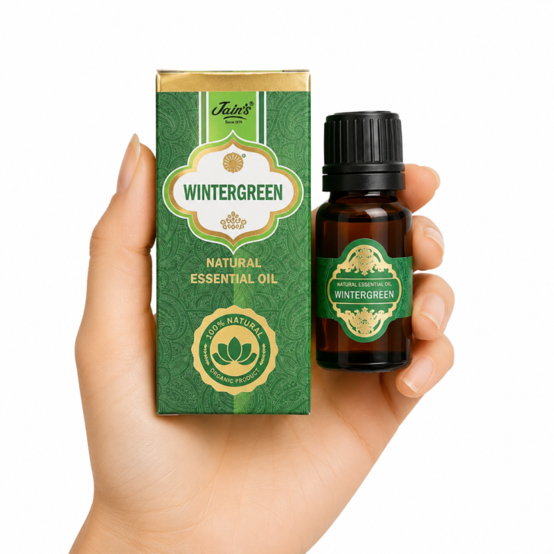 Aceite Esencial de Wintergreen Jain's 100% natural con caja verde y frasco de vidrio ámbar sobre fondo blanco.
