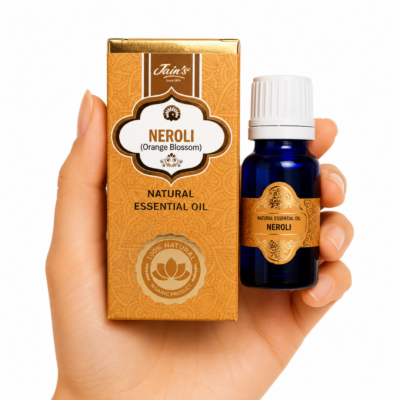 Aceite Esencial de Neroli Jain's 100% natural con caja color ámbar y frasco de vidrio azul sobre fondo blanco.