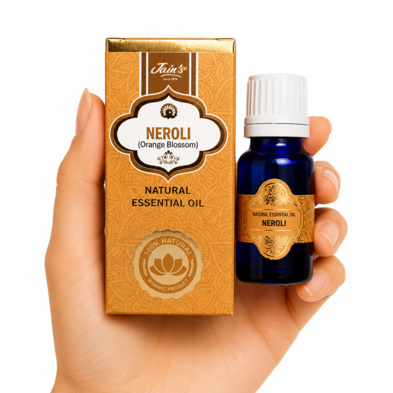Aceite Esencial de Neroli Jain's 100% natural con caja color ámbar y frasco de vidrio azul sobre fondo blanco.
