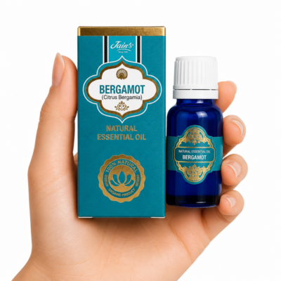 Aceite Esencial de Bergamota Jain's 100% natural con caja azul turquesa y frasco de vidrio azul sobre fondo blanco.