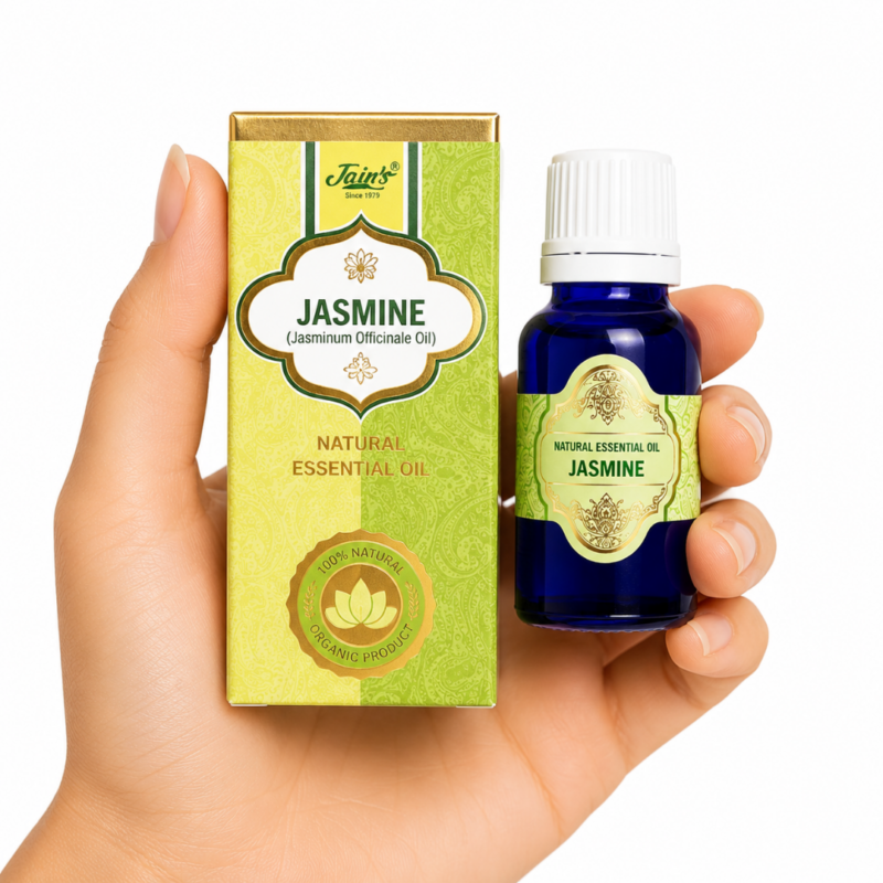 Aceite Esencial de Jazmín (Jasmine) Jain's 100% natural con caja verde y dorada y frasco de vidrio azul sobre fondo blanco.