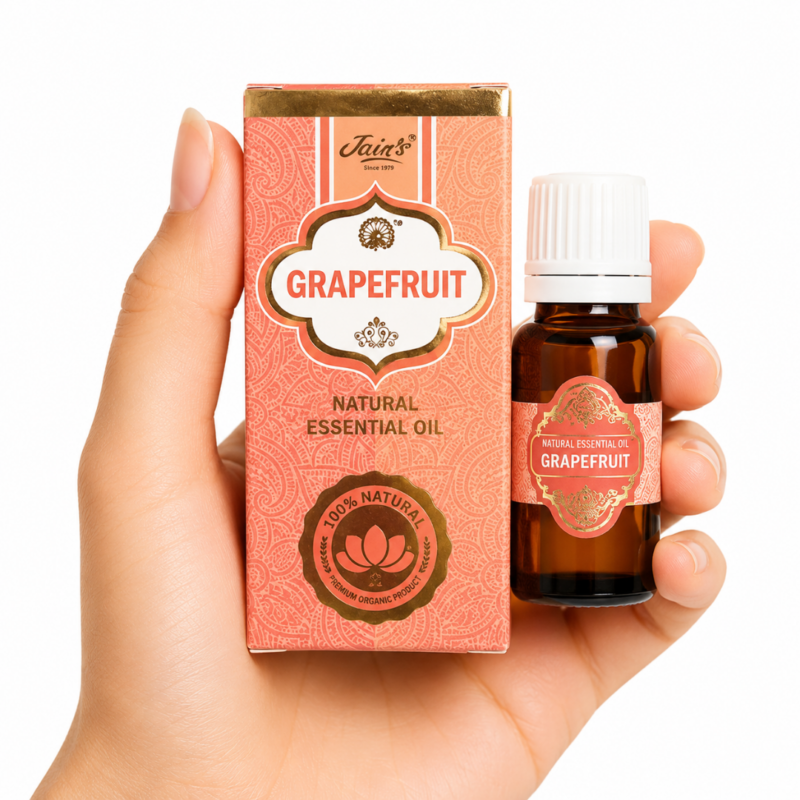 Aceite Esencial de Pomelo (Grapefruit) 100% Natural Jain's con frasco de cristal ámbar y caja original para aromaterapia.
