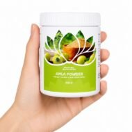 Mano sosteniendo el Amla en Polvo Garuda Ayurveda 100 g sobre fondo blanco.