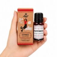 Mano sosteniendo las Gotas Mágicas Happiness de Jains con aceite esencial sobre fondo blanco.
