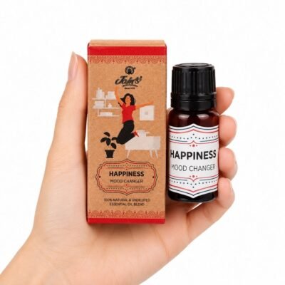 Mano sosteniendo las Gotas Mágicas Happiness de Jains con aceite esencial sobre fondo blanco.